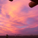 The sun sets behind the farm fields of Mesilla